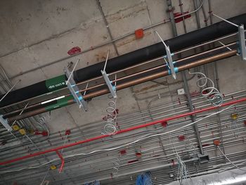 Low angle view of pipes on wall