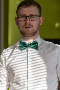 Portrait of young man wearing eyeglasses at home
