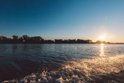 Scenic view of lake against sky during sunset