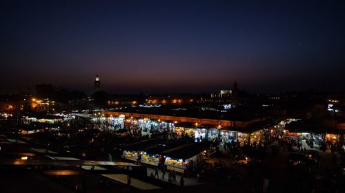 Illuminated city against sky at night