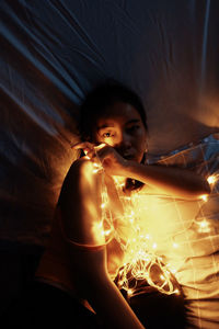 Portrait of man holding lit candle