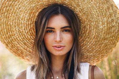 Close-up portrait of beautiful woman wearing hat