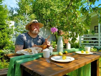 Portrait of a man with drink sitting on table