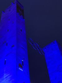 Low angle view of illuminated building against blue sky