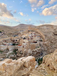 High angle view of rock formations against cloudy sky