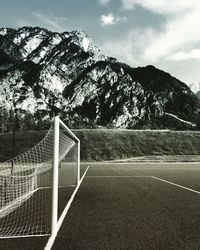 Soccer field against mountain during winter