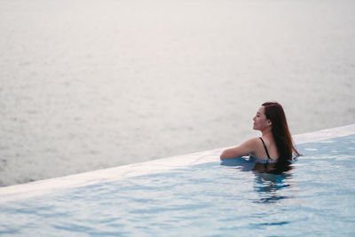 Young woman swimming in sea