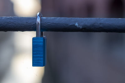 Close-up of padlock hanging on rope