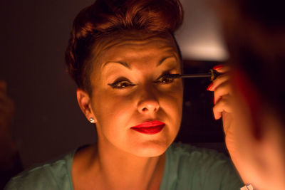 Close-up of woman applying mascara