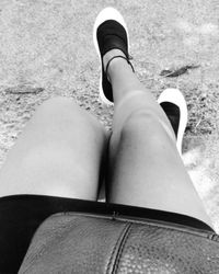 Low section of woman sitting outdoors