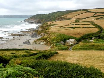 Scenic view of landscape and sea against sky