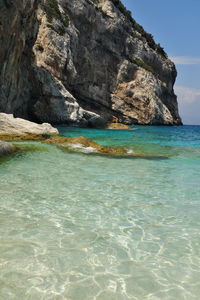 Scenic view of rock formation in sea against sky