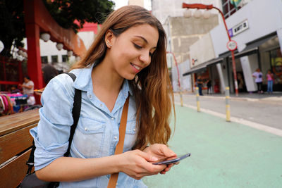 Young woman using mobile phone