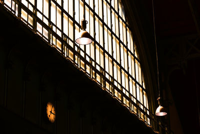 Illuminated pendant light by window in building