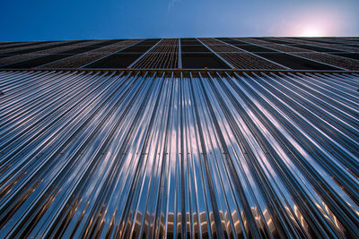 Low angle view of modern building against blue sky