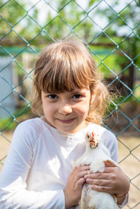 Portrait of girl holding hen