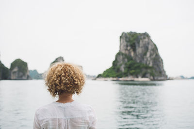 Rear view of woman against sea