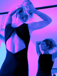 Midsection of woman standing against wall