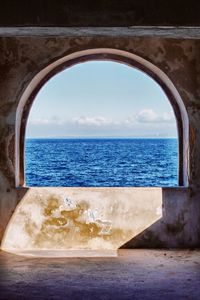 Scenic view of sea against sky seen through window