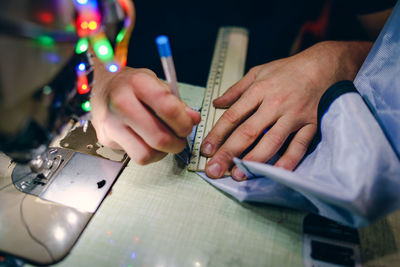 Midsection of man working on table