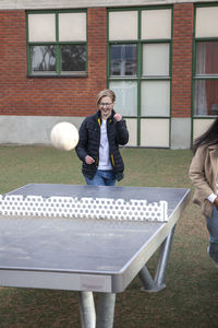 Teenagers playing table ball game