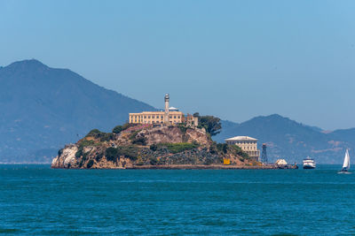 Scenic view of sea and buildings against sky