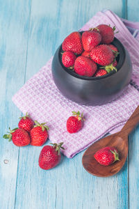 High angle view of strawberries in bowl on table