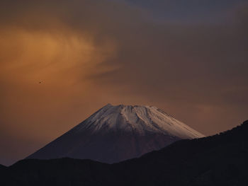 View of snowcapped mountain against cloudy sky