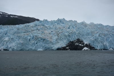 Scenic view of sea and mountains against sky