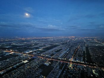 High angle view of illuminated city buildings against sky