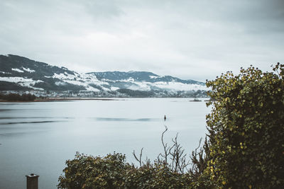 Scenic view of lake and mountains against sky