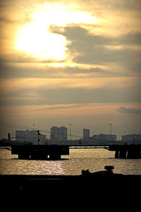 View of city lit up at sunset