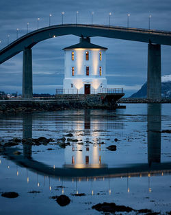 Lepsøyrevet lighthouse with lepsøy bridge in the background, haramsøya, Ålesund, norway.