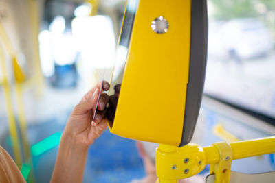 Close-up of person holding yellow camera