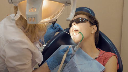 Cropped image of dentist examining patient