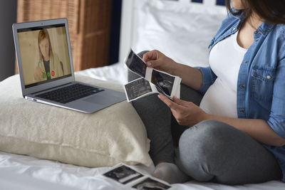 Midsection of woman using mobile phone