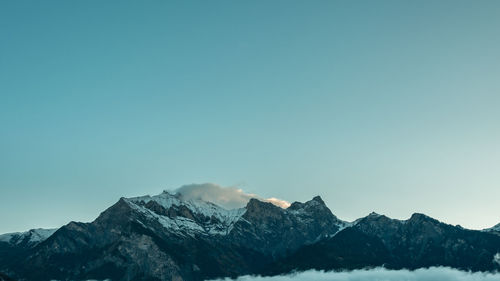 Scenic view of snowcapped mountains against clear sky