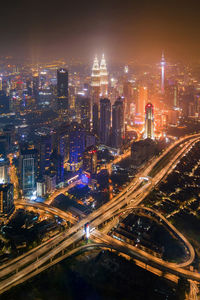 High angle view of city lit up at night