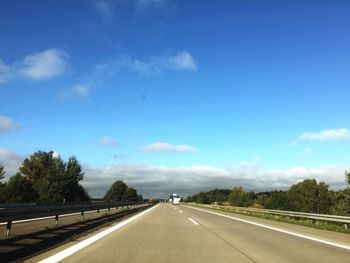 Empty road against cloudy sky