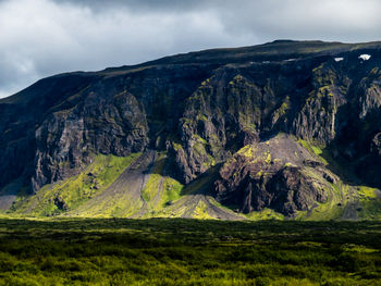 Scenic view of mountains against cloudy sky