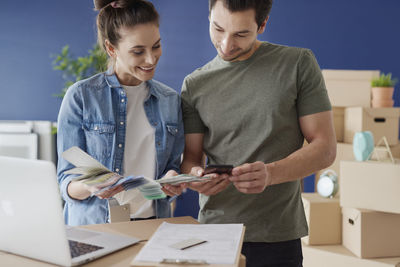Young couple holding smart phone