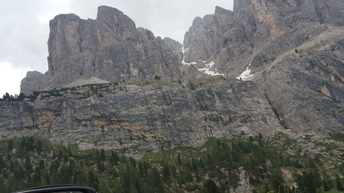 Low angle view of rocky mountains against sky