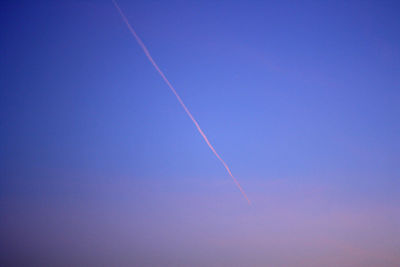 Low angle view of vapor trail in evening sky