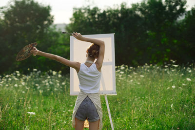 Full length of woman standing on field