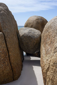 A granite stone suspended above the sand at bay of fires tasmania