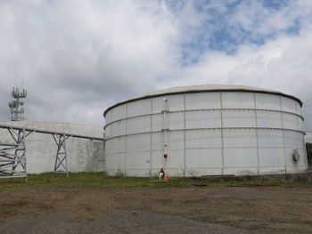 Storage compartment on field against cloudy sky