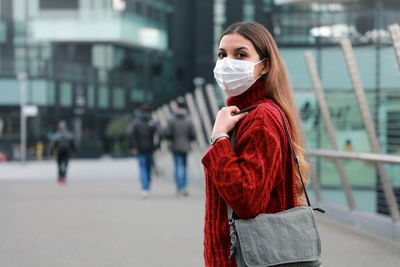 Portrait of woman wearing mask standing outdoors