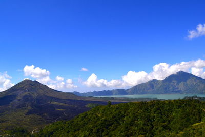 Scenic view of mountains against blue sky