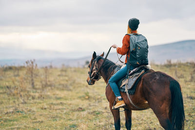 Man riding horse on field