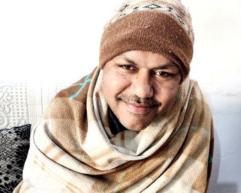 Portrait of smiling young man in snow